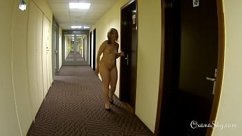 Wearing stockings and heels only  in the hotel corridor